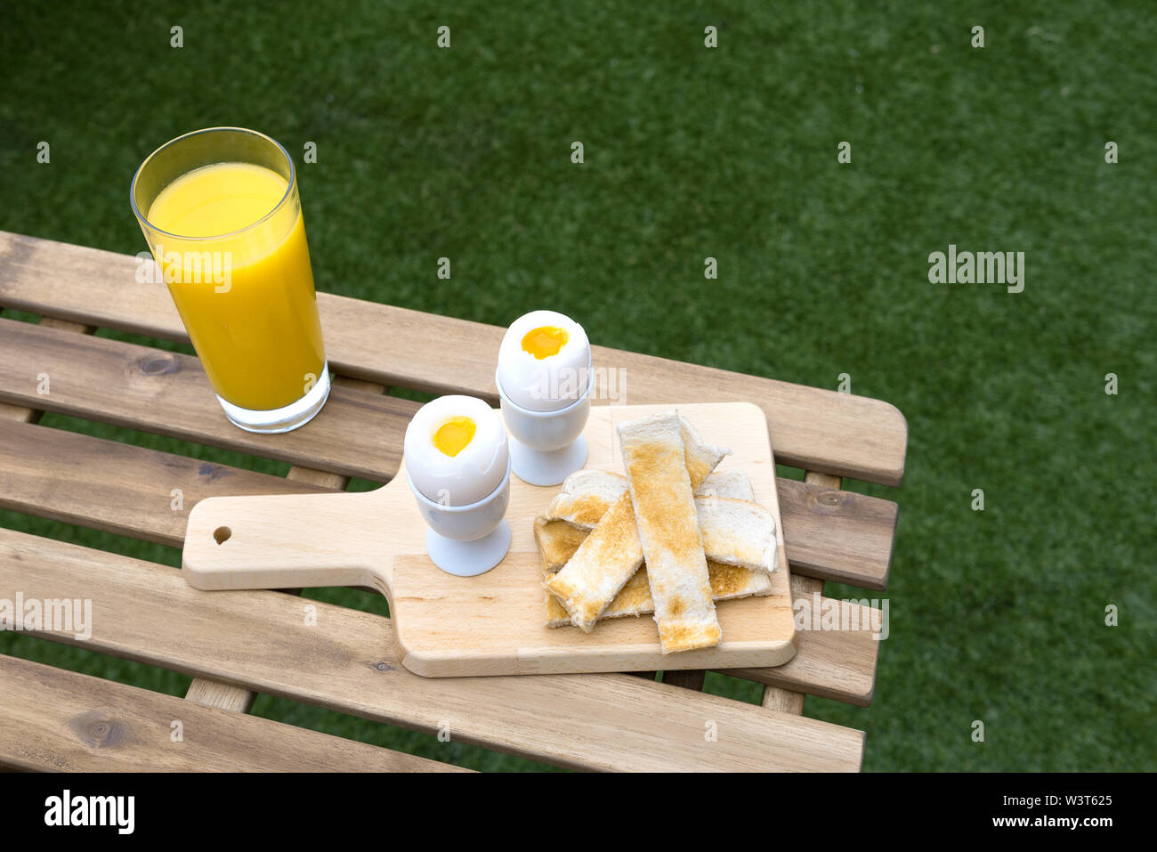Fresh eggs and toast strips with orange juice Stock Photo Alamy