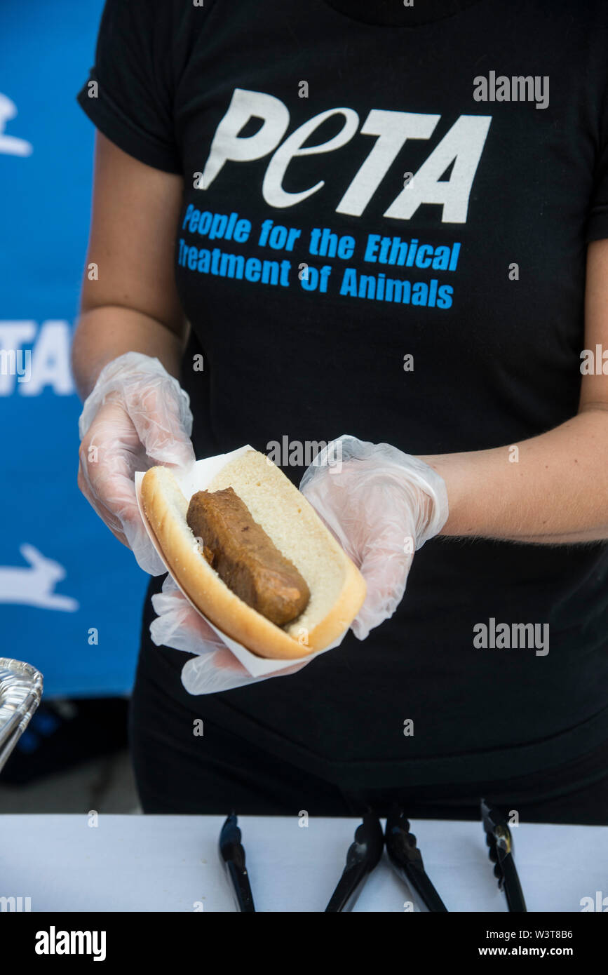 Washington  DC, July 17, 2019, USA:A PETA volunteer holds a meatless dog at the annual PETA (People for the Ethical Treatment of Animals) Veggie dog l Stock Photo