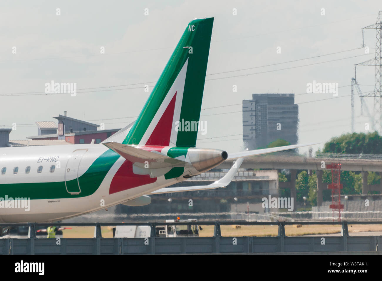 London, Uk - August 2, 2013 - Tail of an Alitalia regional airplane taxiing at London City Airport after landing Stock Photo