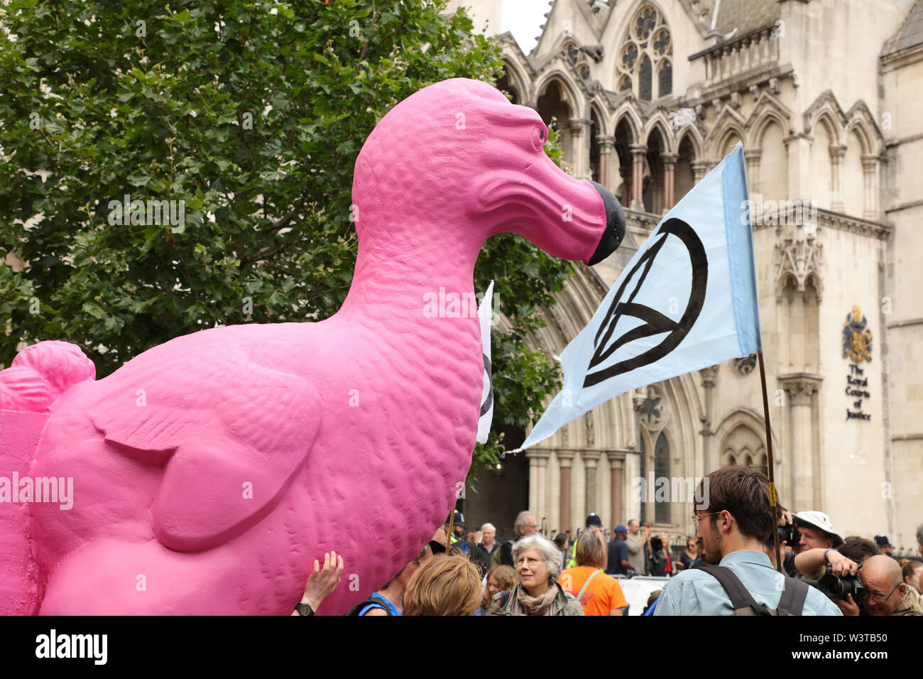 London, UK. 15th July 2019. The climate action group Extinction Rebellion holding protests on several places in the UK such as here in front of the Royal Courts of Law on the Strand, London, closing part of the street demanding a law on Ecocide. Credit: Joe Kuis / Alamy News Stock Photo