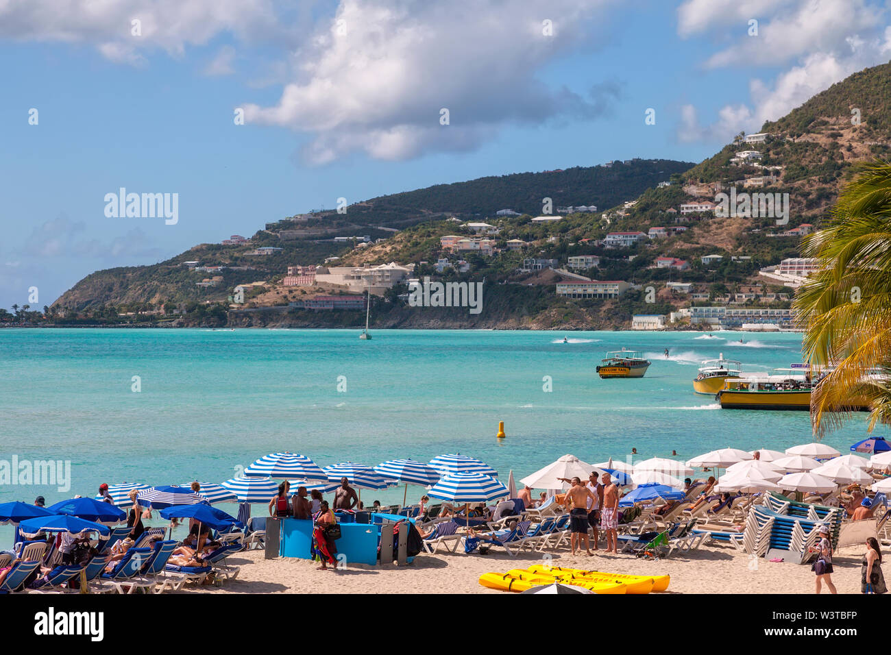 Sint Maarten, Kingdom of the Netherlands - January 19, 2011: Crowded beach in Philipsburg, capital city of Sint Maarten, is an attraction for visitors Stock Photo