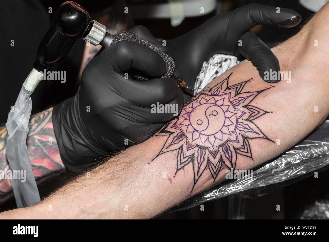 Tattoo in form of circular pattern on man's arm Stock Photo - Alamy