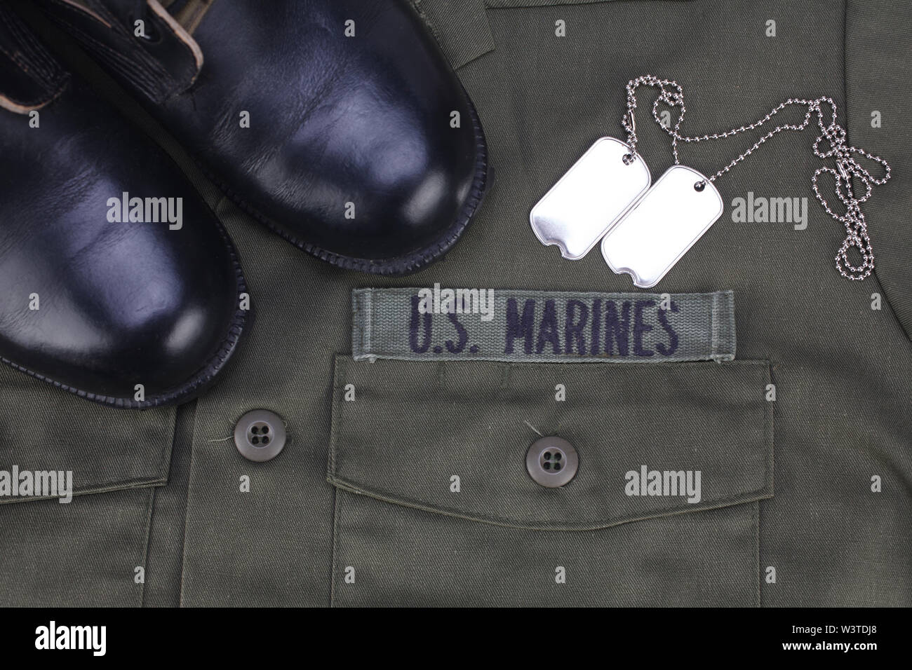 U.S. MARINES Tape with dog tags and boots on olive green uniform