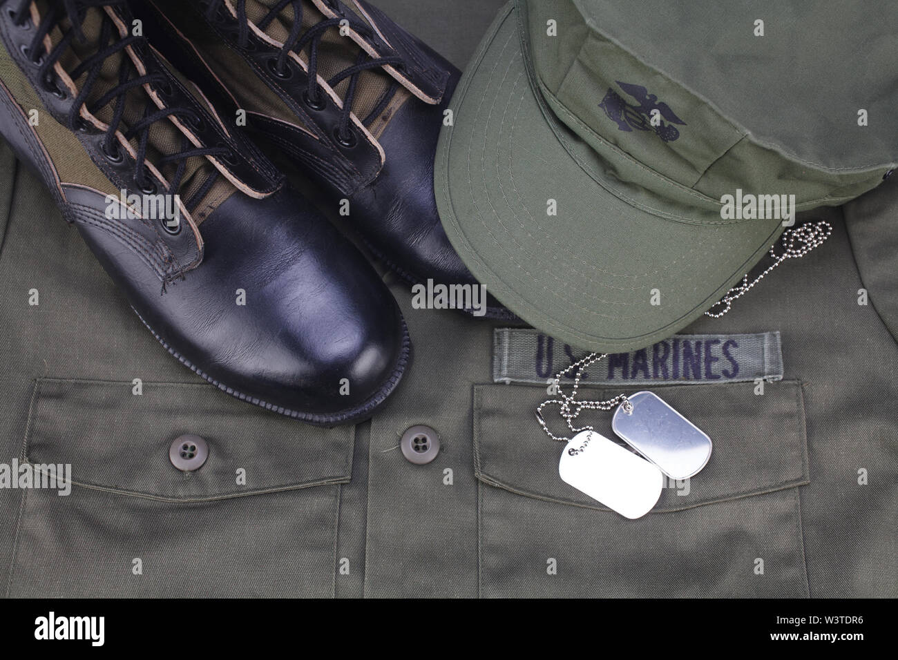 U.S. MARINES Tape with dog tags and boots on olive green uniform