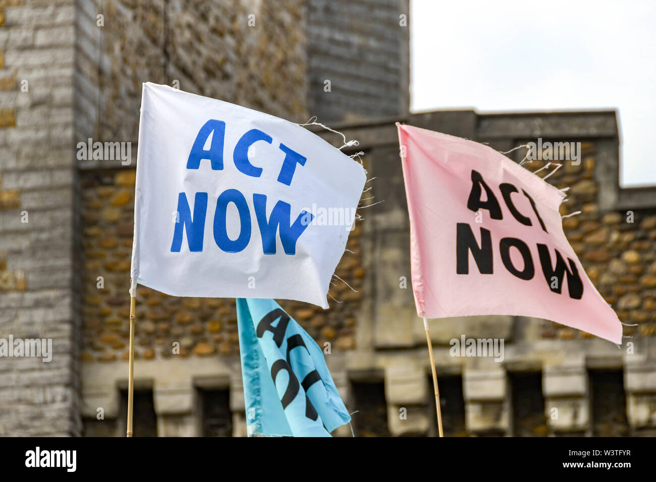 CARDIFF, WALES - JULY 2019: Close up of 'Act Now' flags in Cardiff city centre at a Climate Emergency protest by Extinction Rebellion. Stock Photo