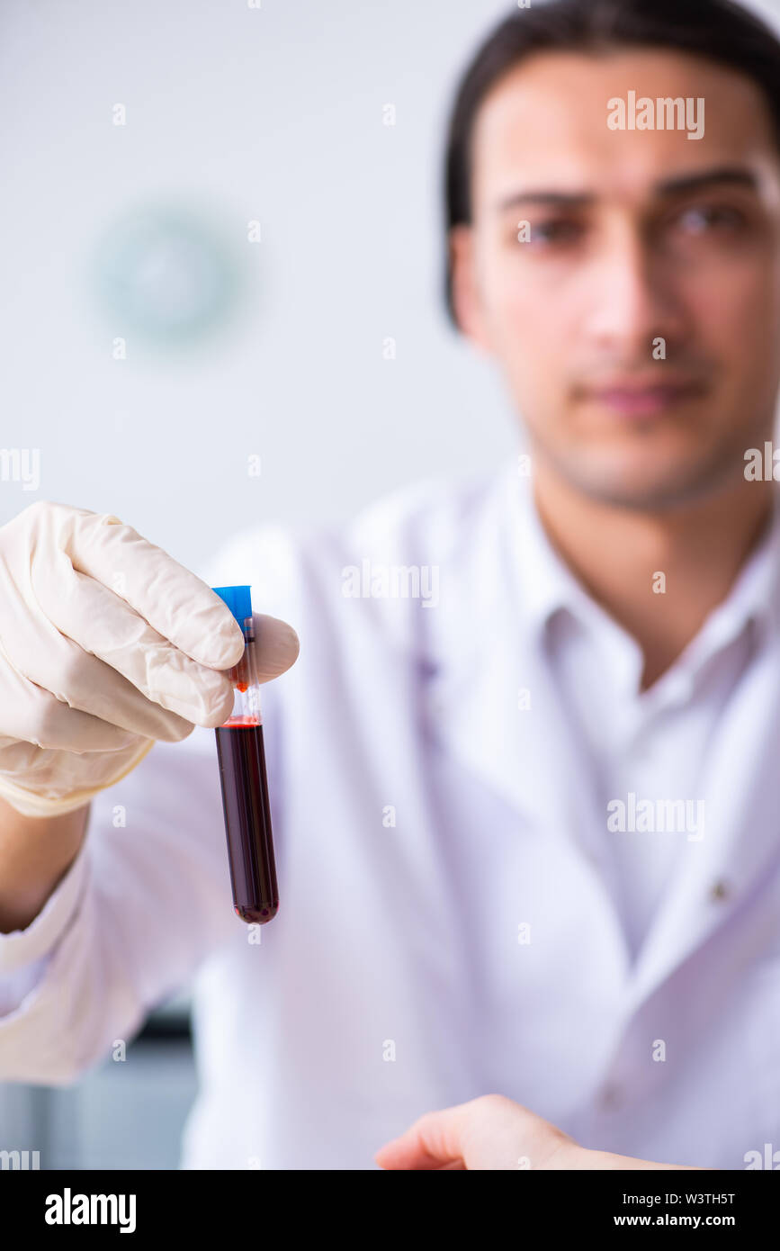 The young lab assistant testing blood samples in hospital Stock Photo