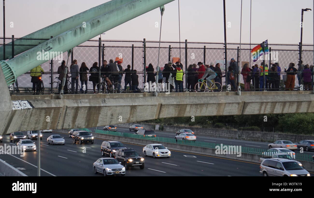 Lights For Liberty vigil on the University Avenue Pedestrian Bridge in Berkeley over Highway 80, to protest US ICE detention centers. Stock Photo
