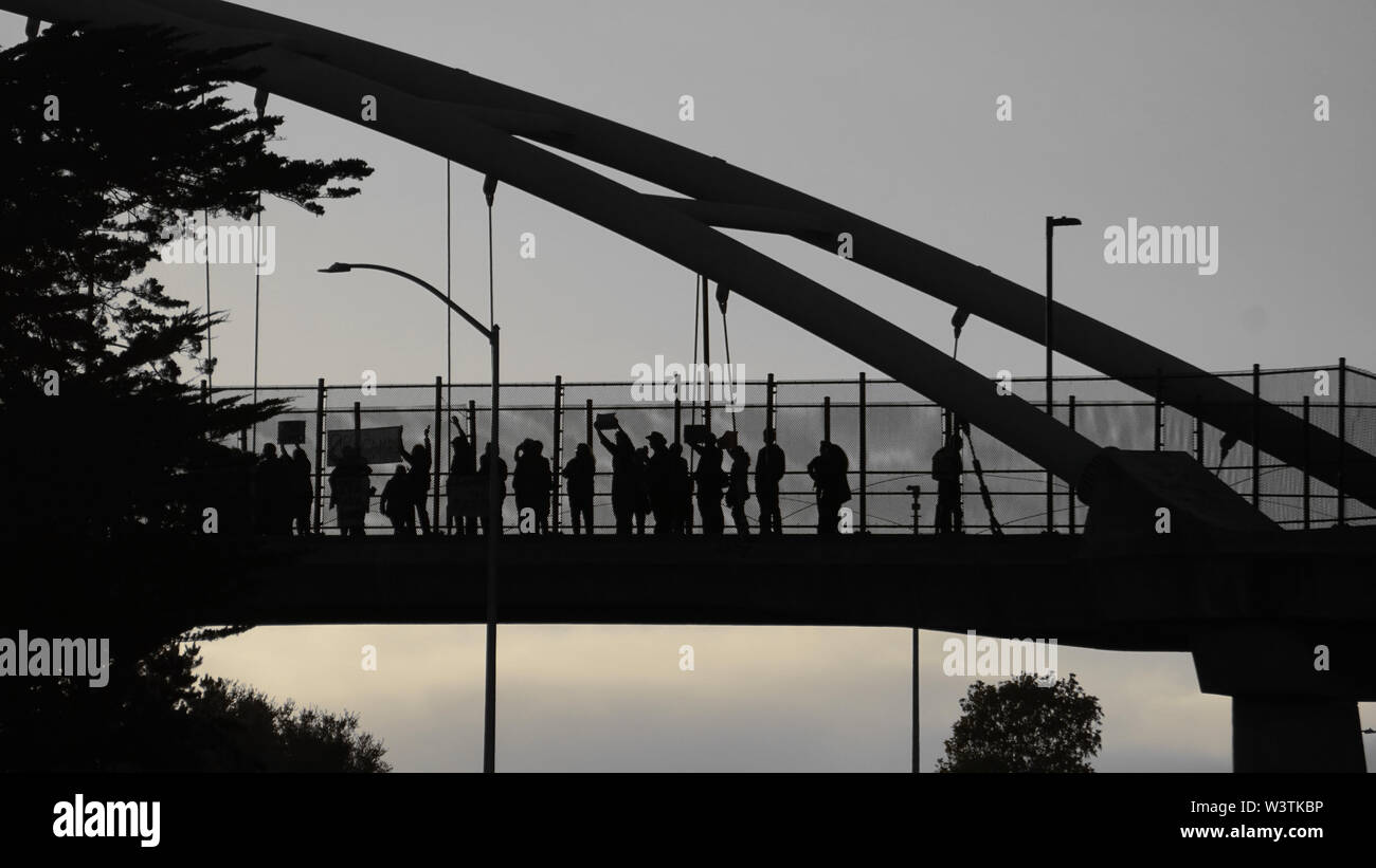 Lights For Liberty vigil on the University Avenue Pedestrian Bridge in Berkeley over Highway 80, to protest US ICE detention centers. Stock Photo
