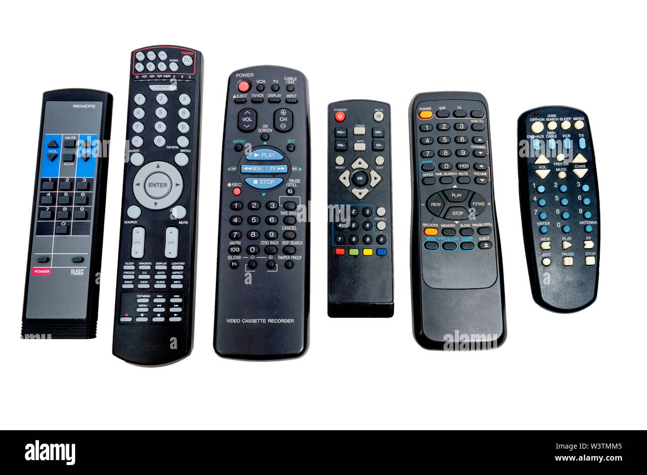 Horizontal shot of a row of six lined up dirty used remote controls ...