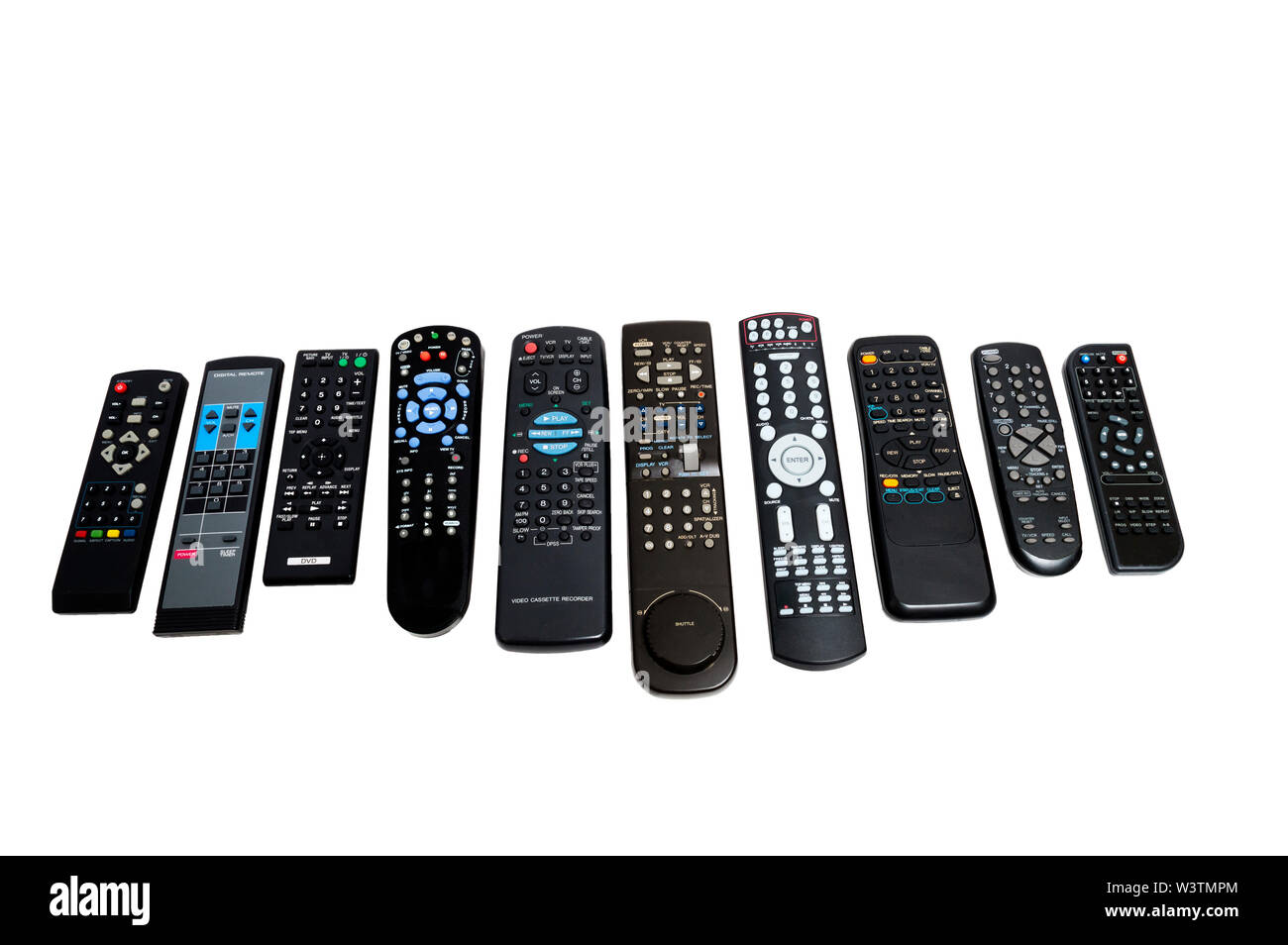 Horizontal shot of a row of ten lined up dirty used remote controls.  Different sizes and button configurations.  White background. Stock Photo