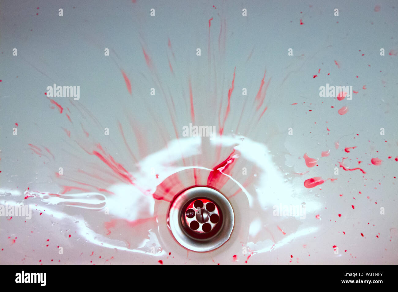 Red drops and blood stains on a white surface. The concept of bloody suicide and disease Stock Photo