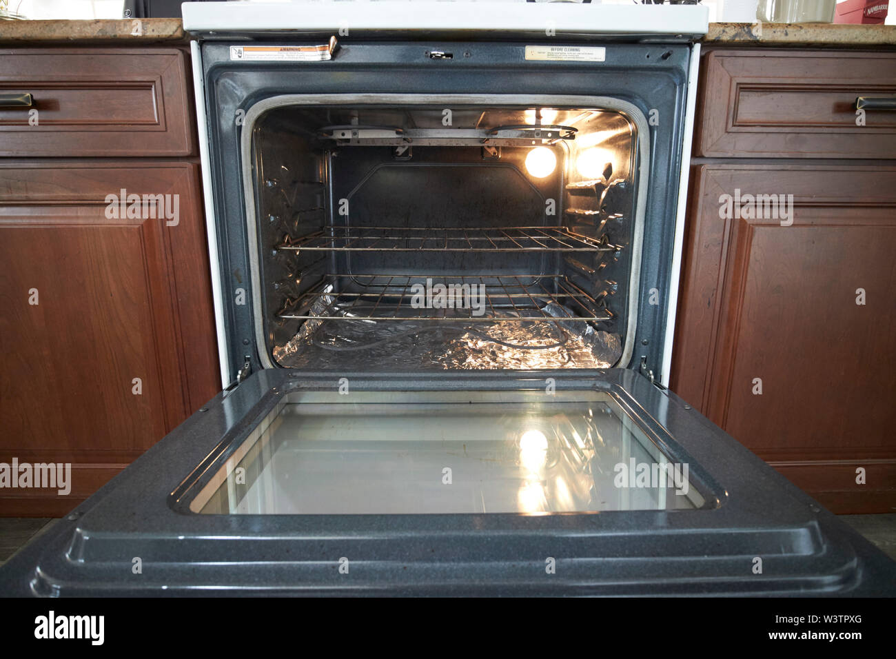 open electric oven door in a kitchen in the USA United States of America Stock Photo