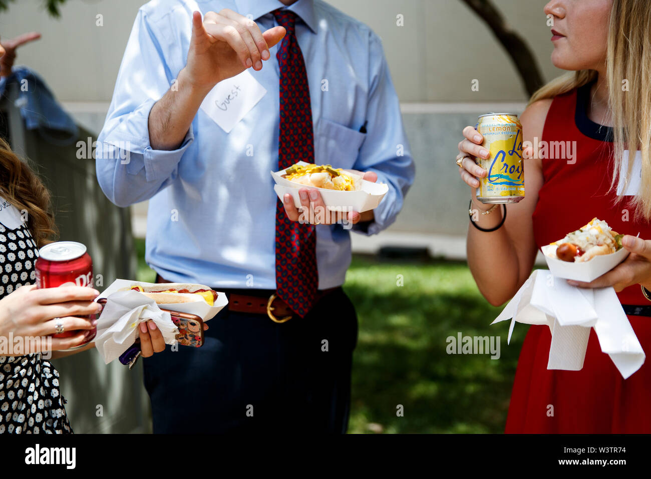 Washington, USA. 17th July, 2019. People eat hot dogs during the annual Hot Dog Lunch event at the Rayburn House Office Building on Capitol Hill in Washington, DC, the United States, on July 17, 2019. The event was held here on Wednesday in celebration of the National Hot Dog Day. Credit: Ting Shen/Xinhua/Alamy Live News Stock Photo