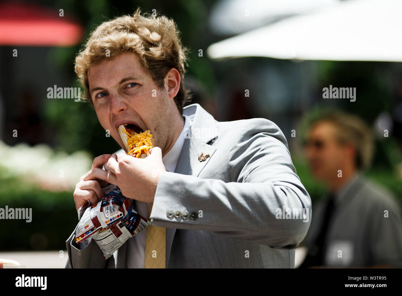 Washington, USA. 17th July, 2019. A man eats a hot dog during the annual Hot Dog Lunch event at the Rayburn House Office Building on Capitol Hill in Washington, DC, the United States, on July 17, 2019. The event was held here on Wednesday in celebration of the National Hot Dog Day. Credit: Ting Shen/Xinhua/Alamy Live News Stock Photo