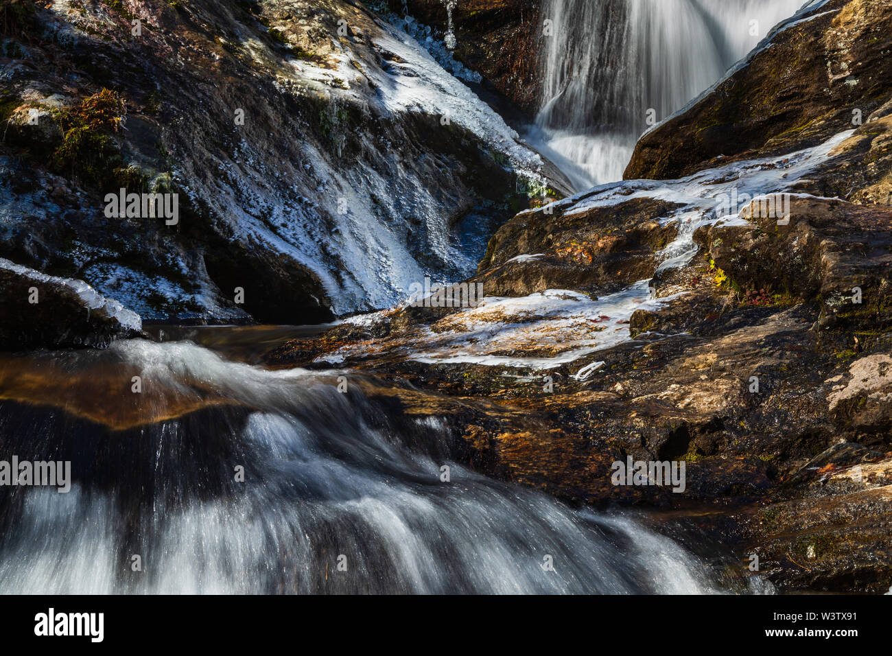 Close up view of an icy Tom's Creek below the falls near Marion, North Carolina, USA. The 60-foot falls are located on Tom's Creek, near Marion, NC. Stock Photo