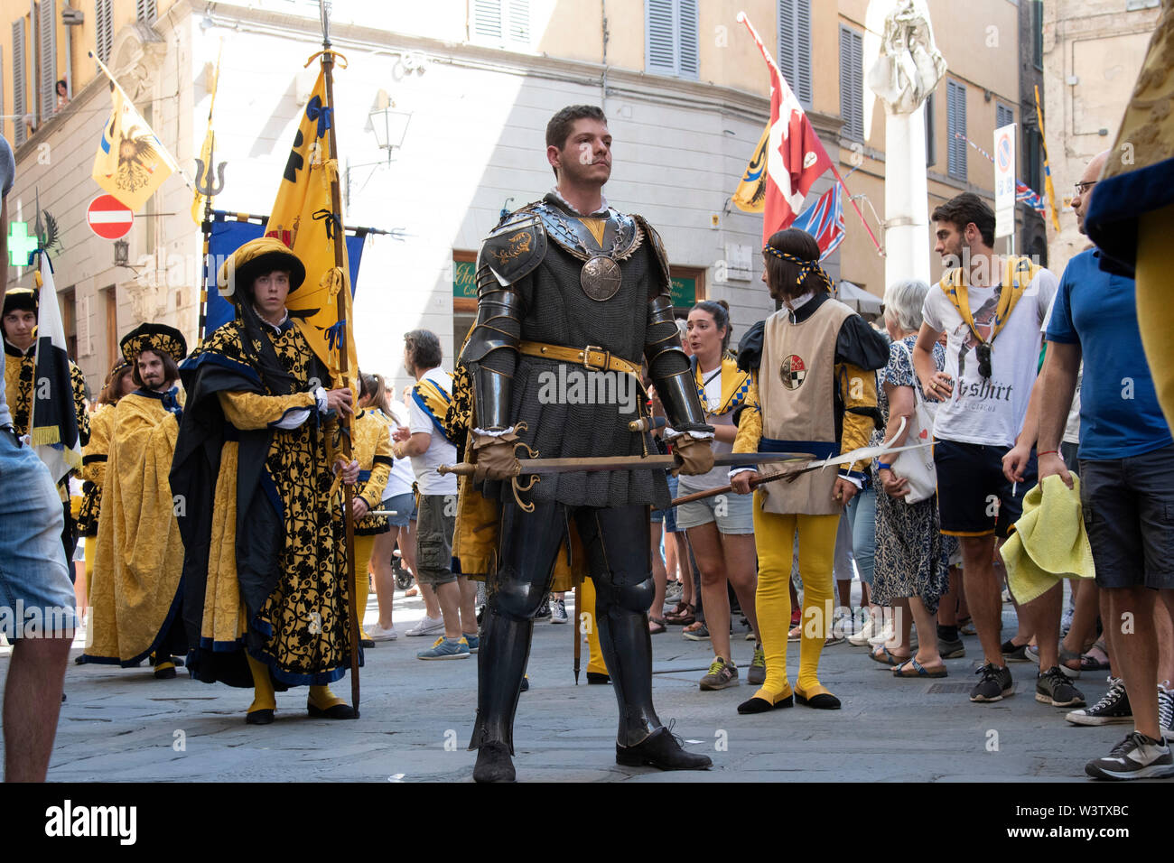 A handsome man dressed in historical medieval costume and garb marches in the historic Palio parade in Siena, Italy Stock Photo