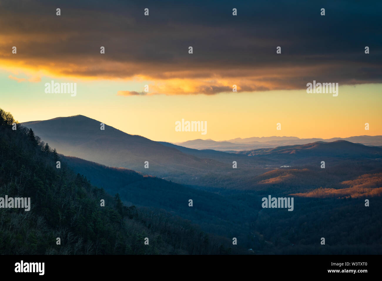 First light reaches North Cove valley, North Carolina, USA. On the left are Honeycutt Ridge and Linville Mountain. Stock Photo