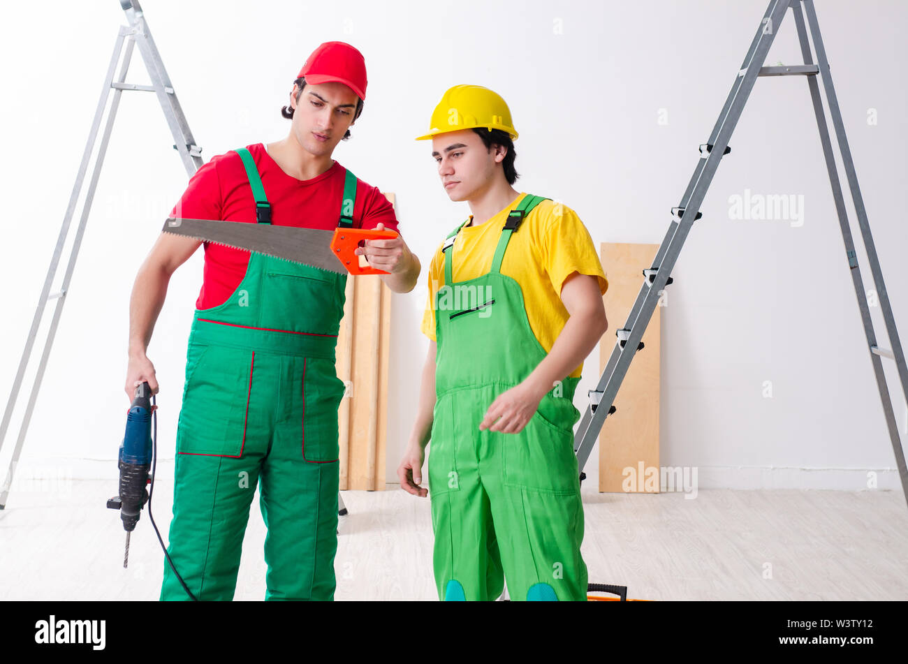 The two workers contractors working indoors Stock Photo