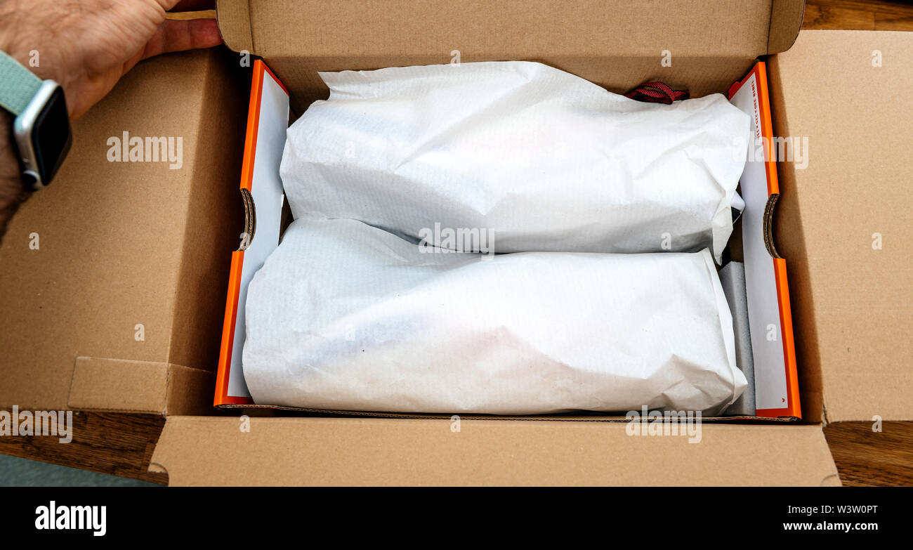 Paris France - Jul 13 2019: Above view unboxing unpacking sport running  shoes equipment manufactured byu Nike sportswear - cardboard box open with  silhouettes of two shoes Stock Photo - Alamy