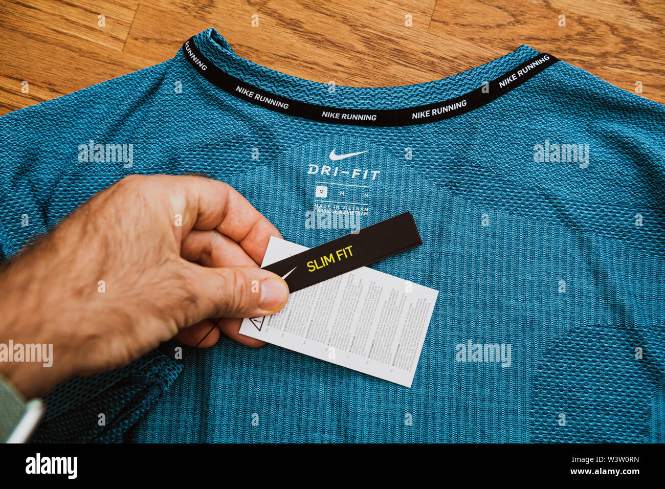 Paris, France - Jul 13, 2019: Man hand POV unboxing unpacking admiring  latest sport clothes equipment for running manufactured byu Nike sportswear  slim fit size Dri Fi Made in Vietnam Stock Photo - Alamy