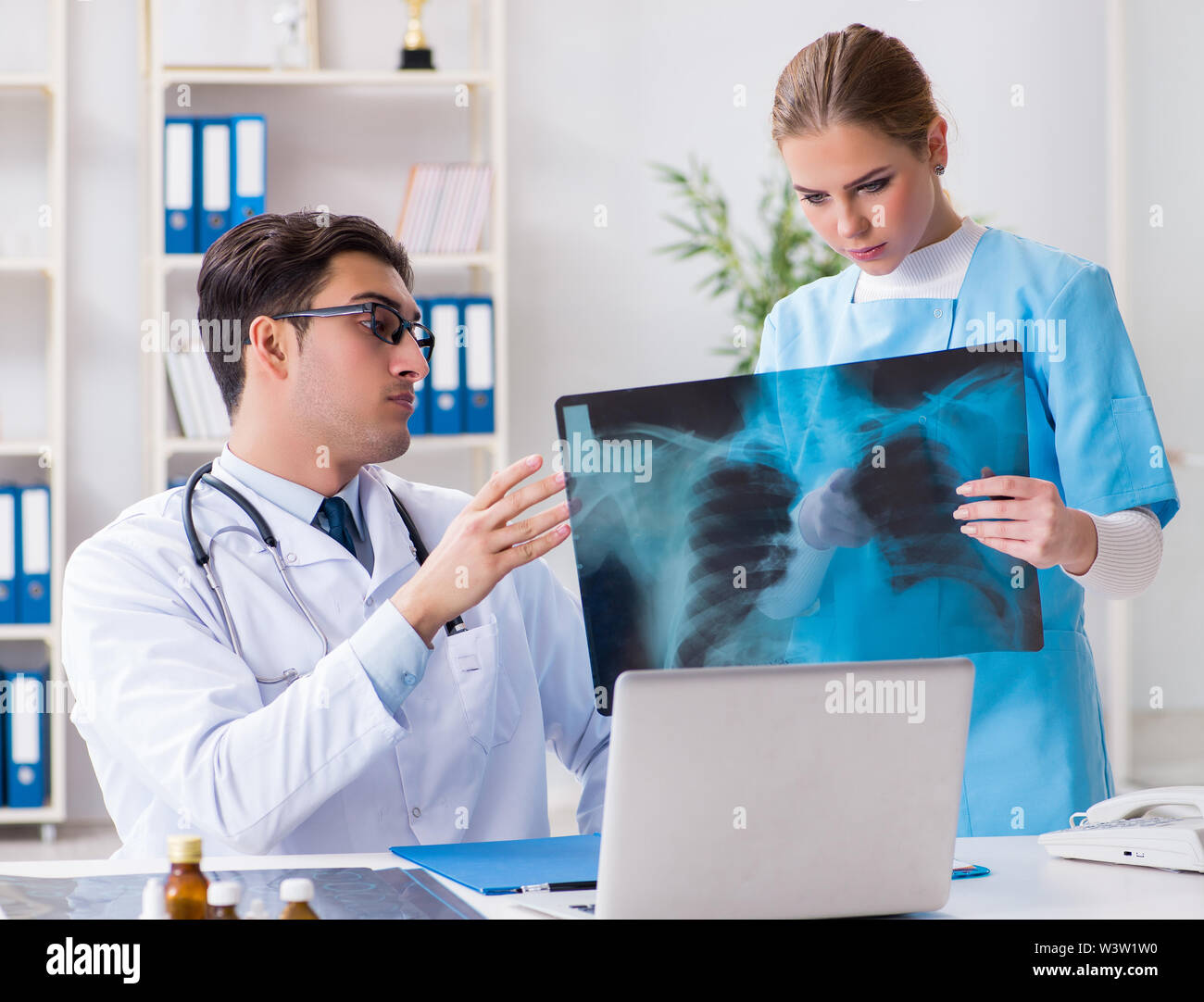 The two doctors examining xray images of patient for diagnosis Stock