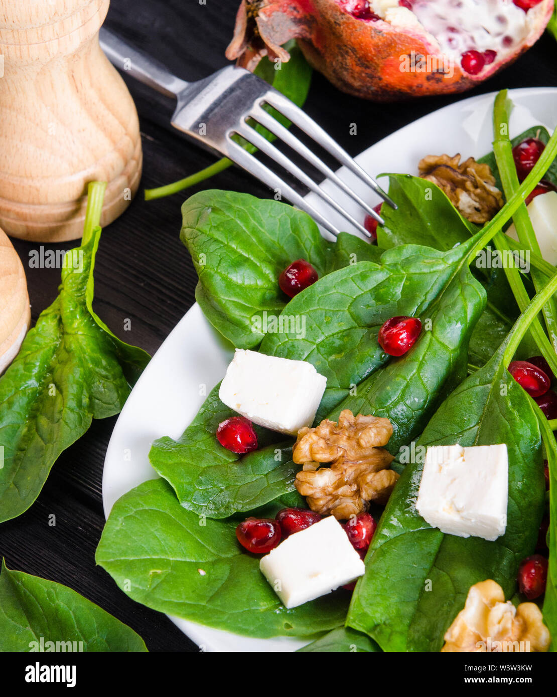 The spinach salad with nuts and apples served on table Stock Photo Alamy