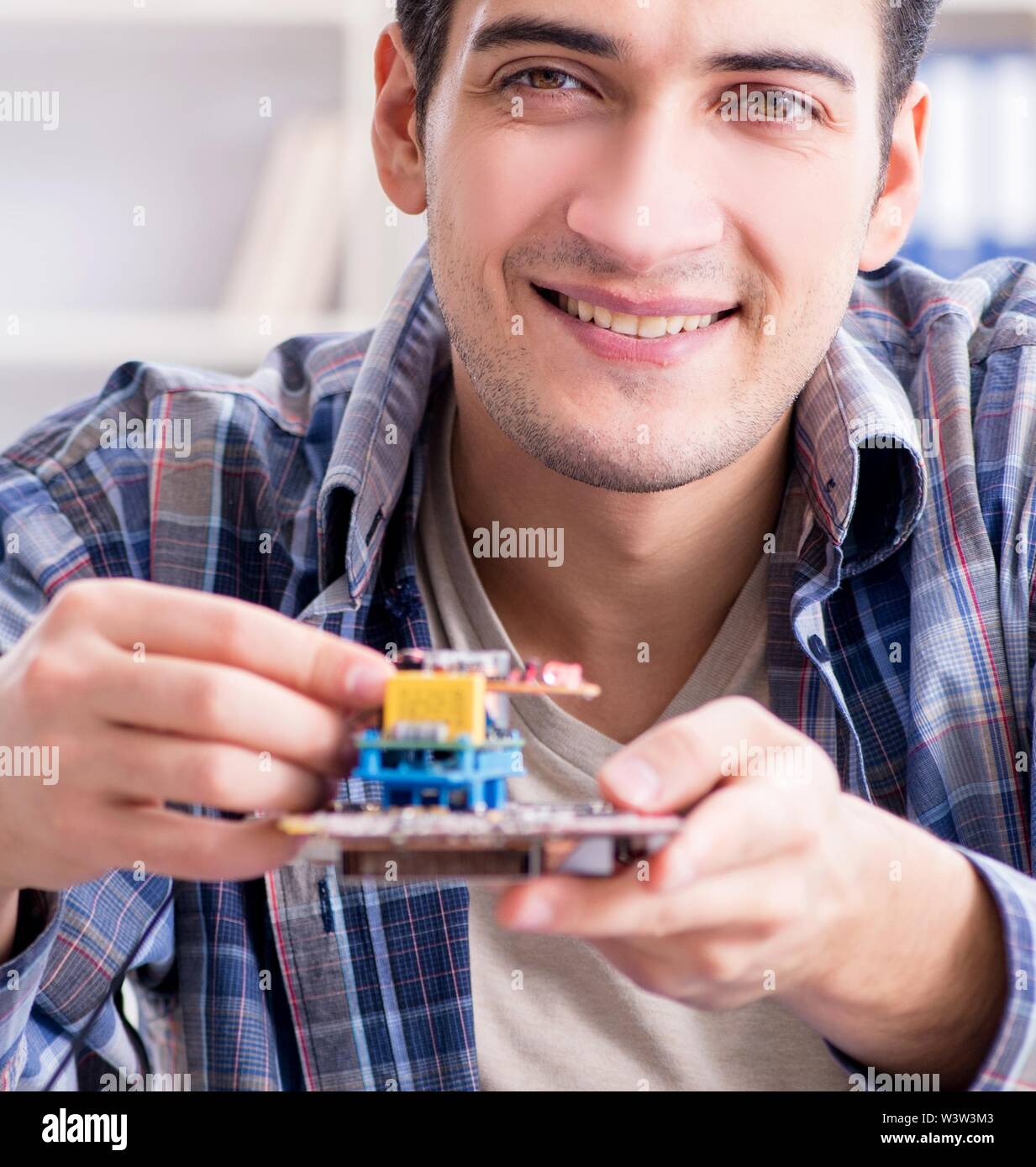 The professional repairman repairing computer in Stock Photo