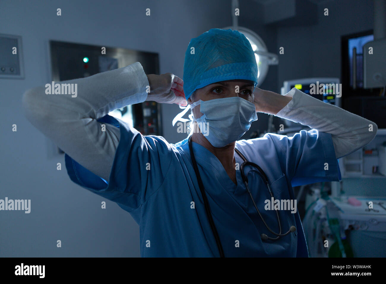 Surgeon wearing surgical mask in operating room of hospital Stock Photo ...
