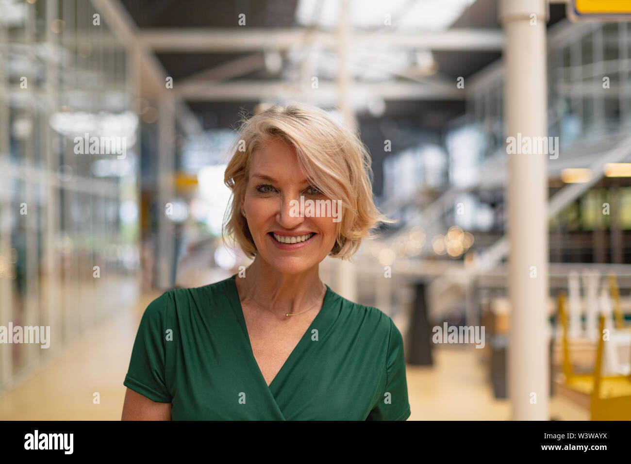 Happy mature female standing hi-res stock photography and images - Alamy