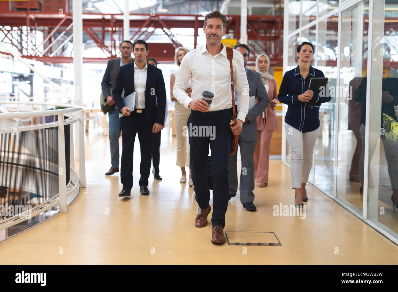 Business people walking together in a modern office Stock Photo - Alamy