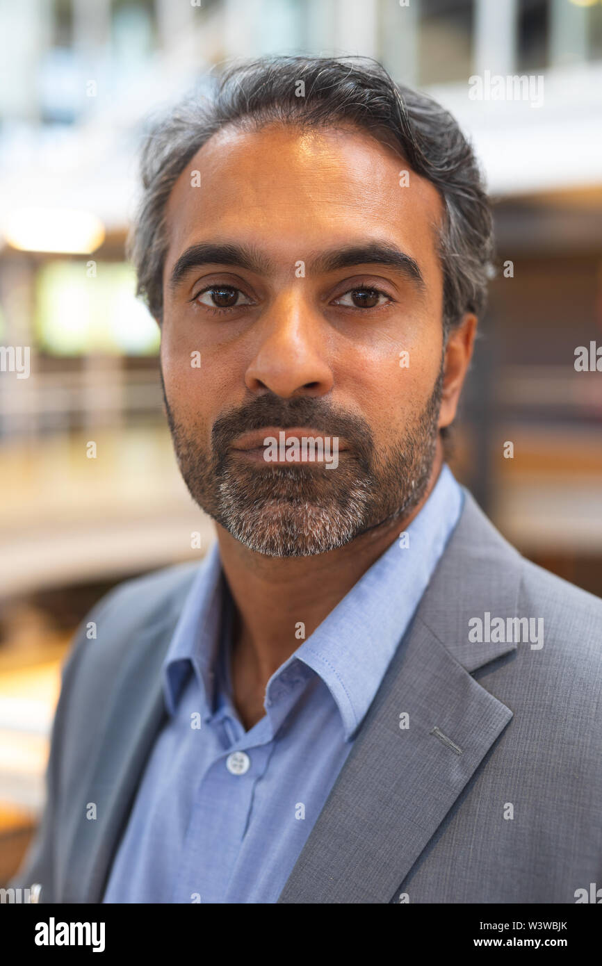 Mature businessman looking at camera in a modern office Stock Photo - Alamy