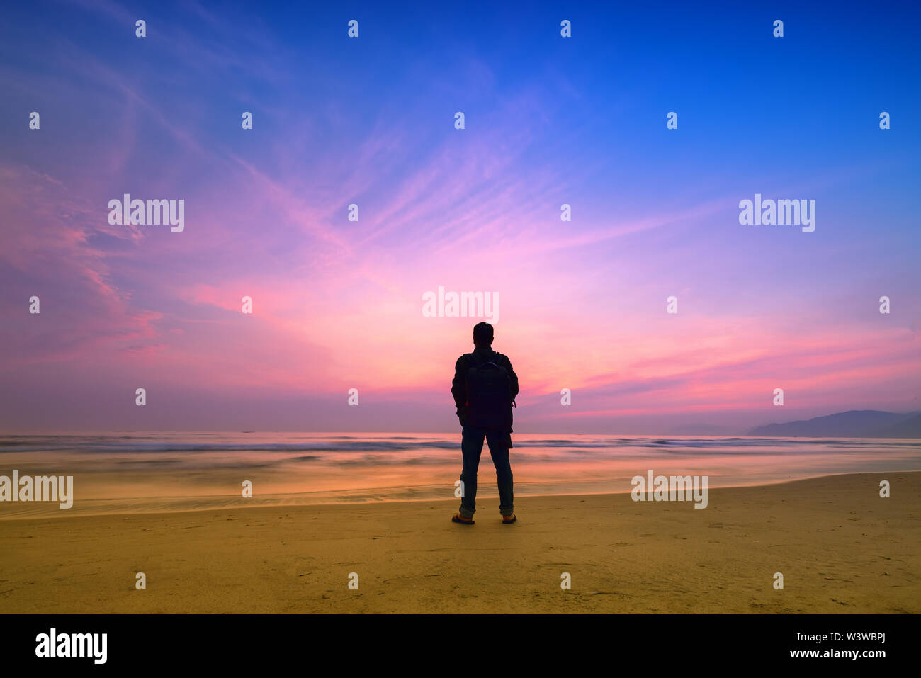 Silhouette man standing in front of the sea with sunrise sky in the morning  as a way to relax during travel new land in Hue, Vietnam Stock Photo - Alamy