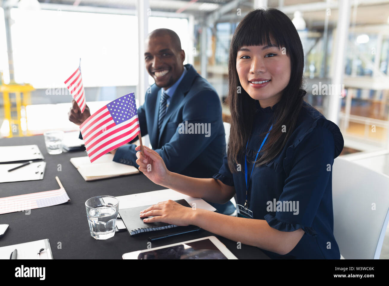 Business people sitting at conference registration table Stock Photo