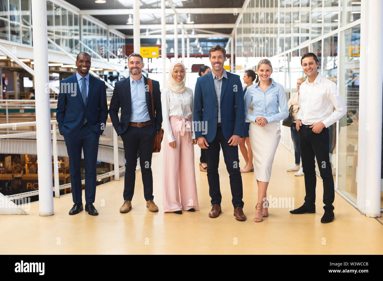 Business people standing together in corridor at office Stock Photo - Alamy