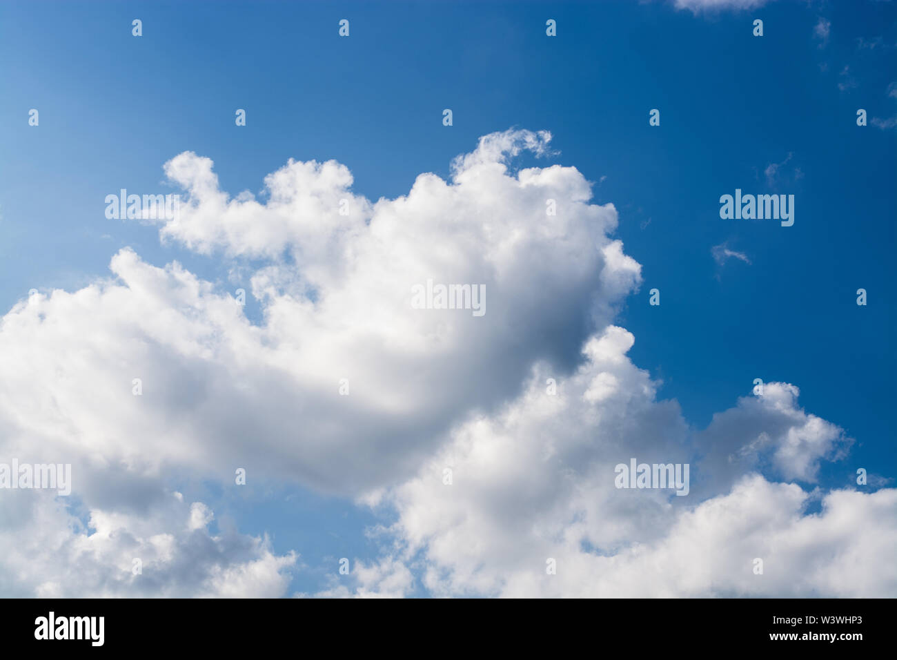 Bright blue sky with clean white airy fluffy clouds on a summer day ...