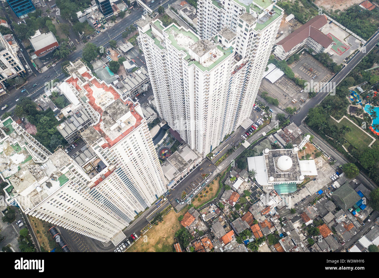 Contrast between modern apartment tower and traditional working class