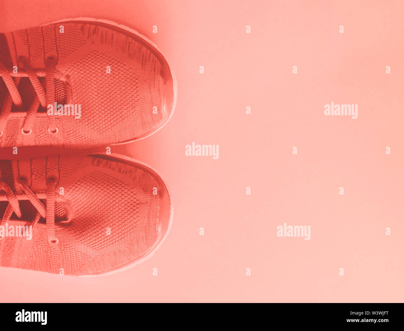 Coral pink trainers on empty background. Flat lay Stock Photo - Alamy