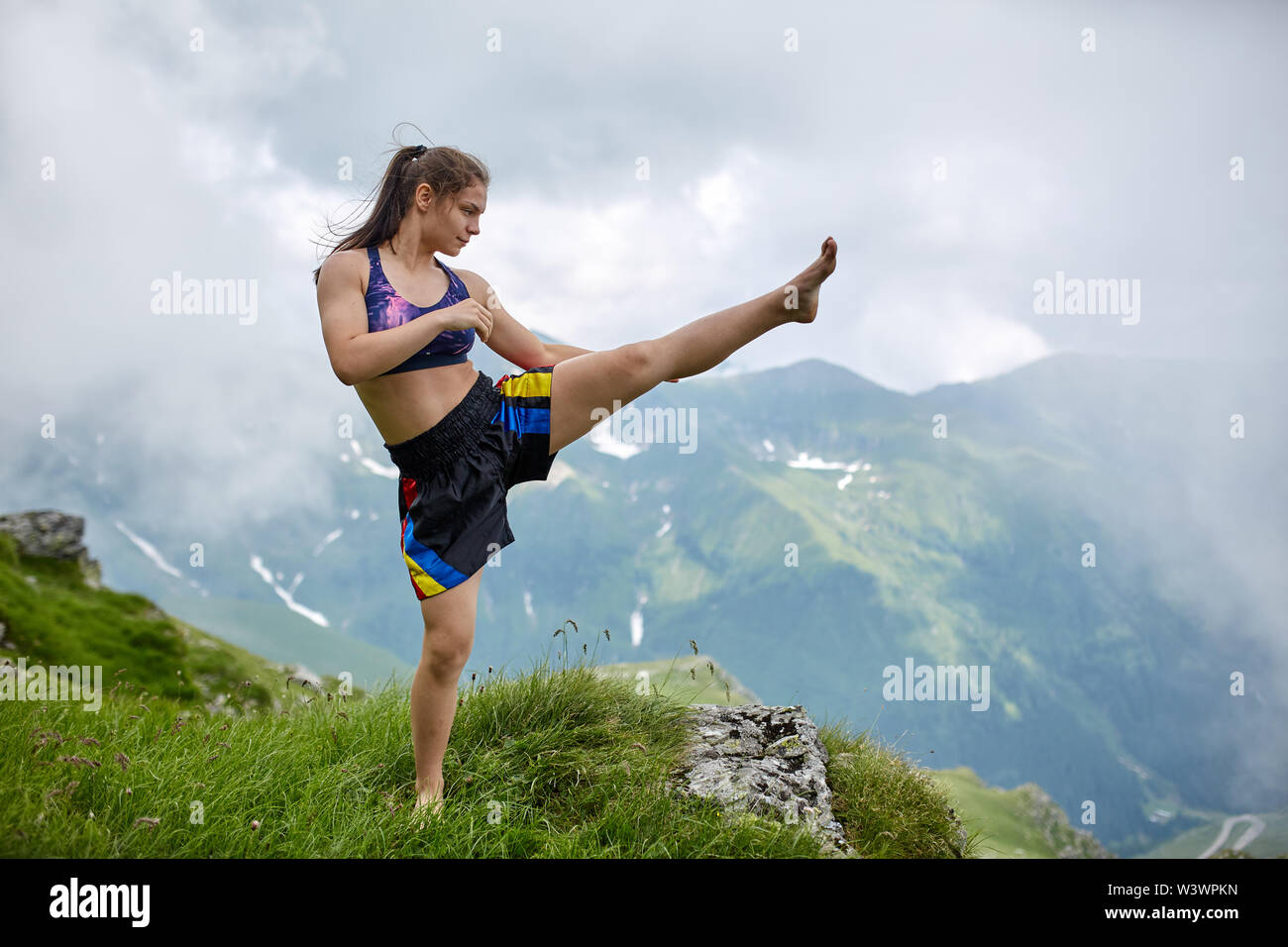 Young female kickboxer training on the mountain Stock Photo
