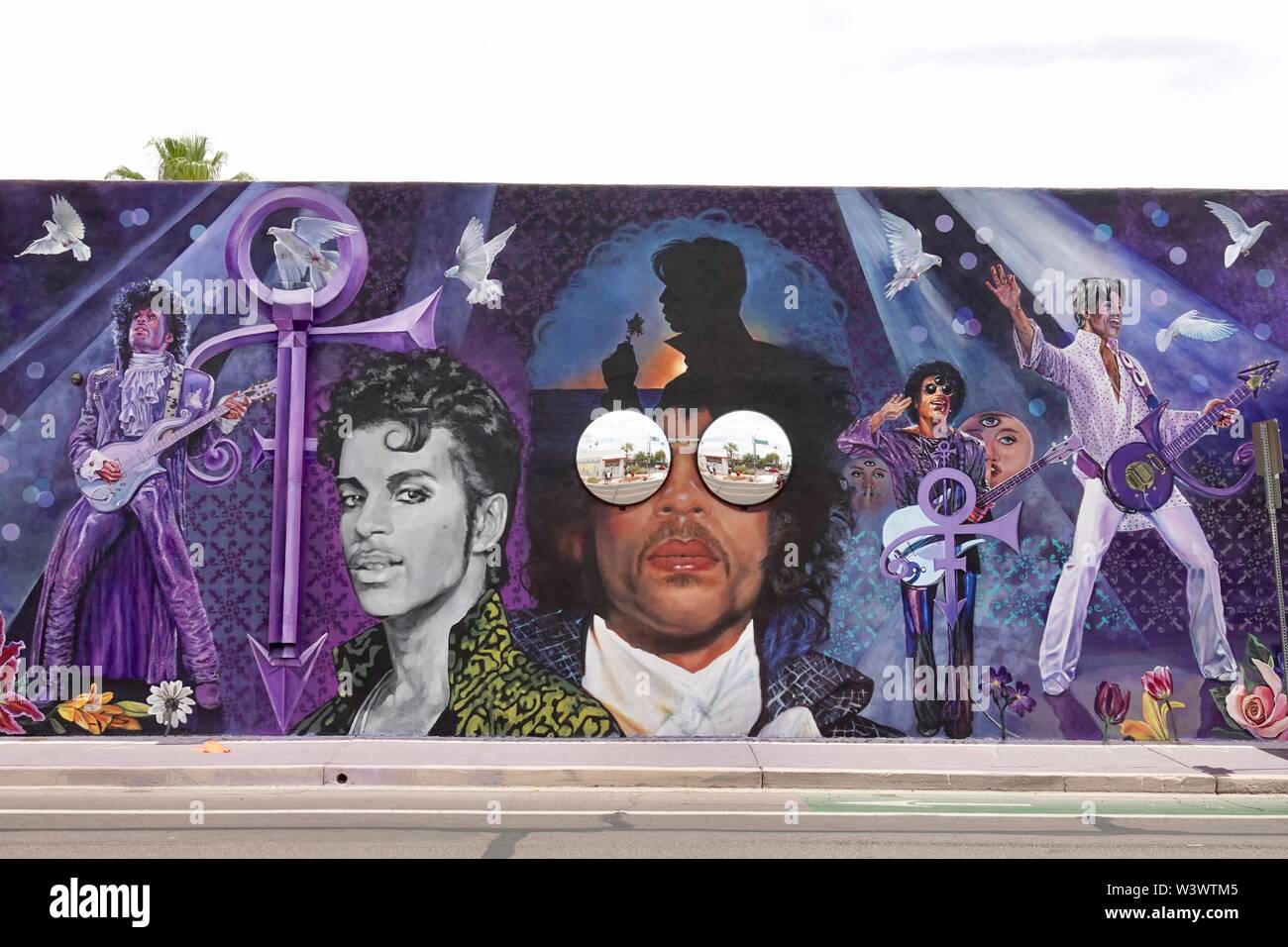 A mural in honor of musician Prince on a side of a building in downtown