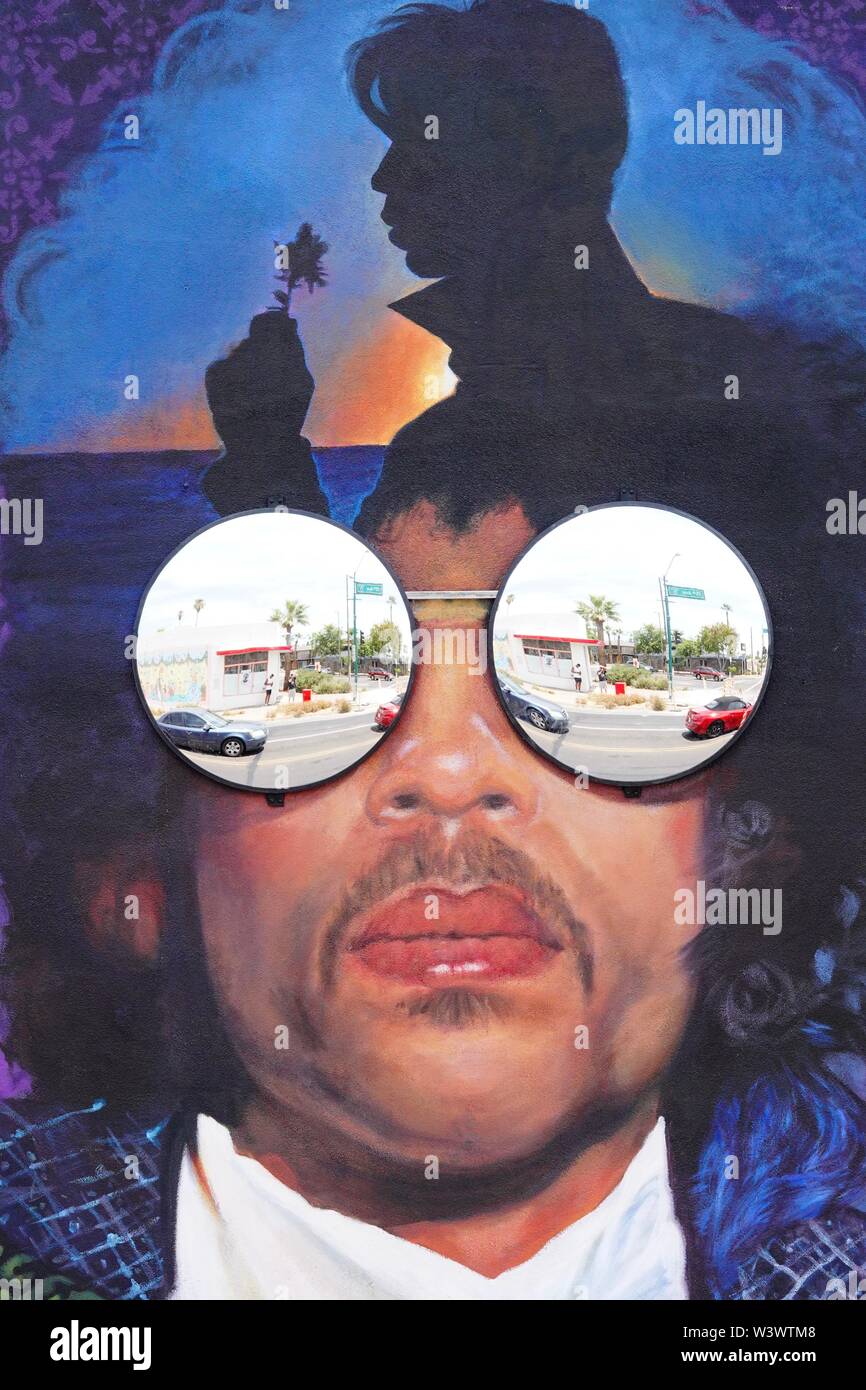 A mural in honor of musician Prince on a side of a building in downtown