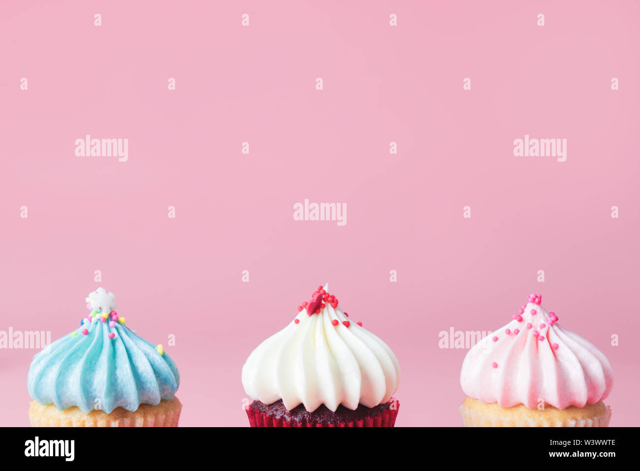 Pastel tone tree cupcakes on pink copy space for part text Stock Photo