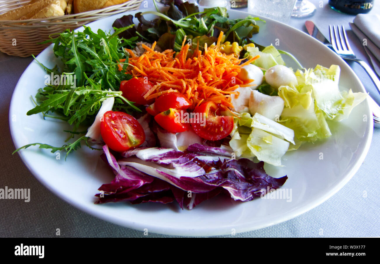 Fresh salad with tomatoes, tuna, chicory and carrots Stock Photo