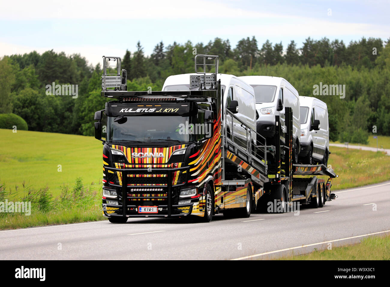Salo, Finland - June 29, 2019: Unique vehicle carrier Scania R650 of Kuljetus J. Kivi hauls Ford transit vans on highway 52 on a day of summer. Stock Photo