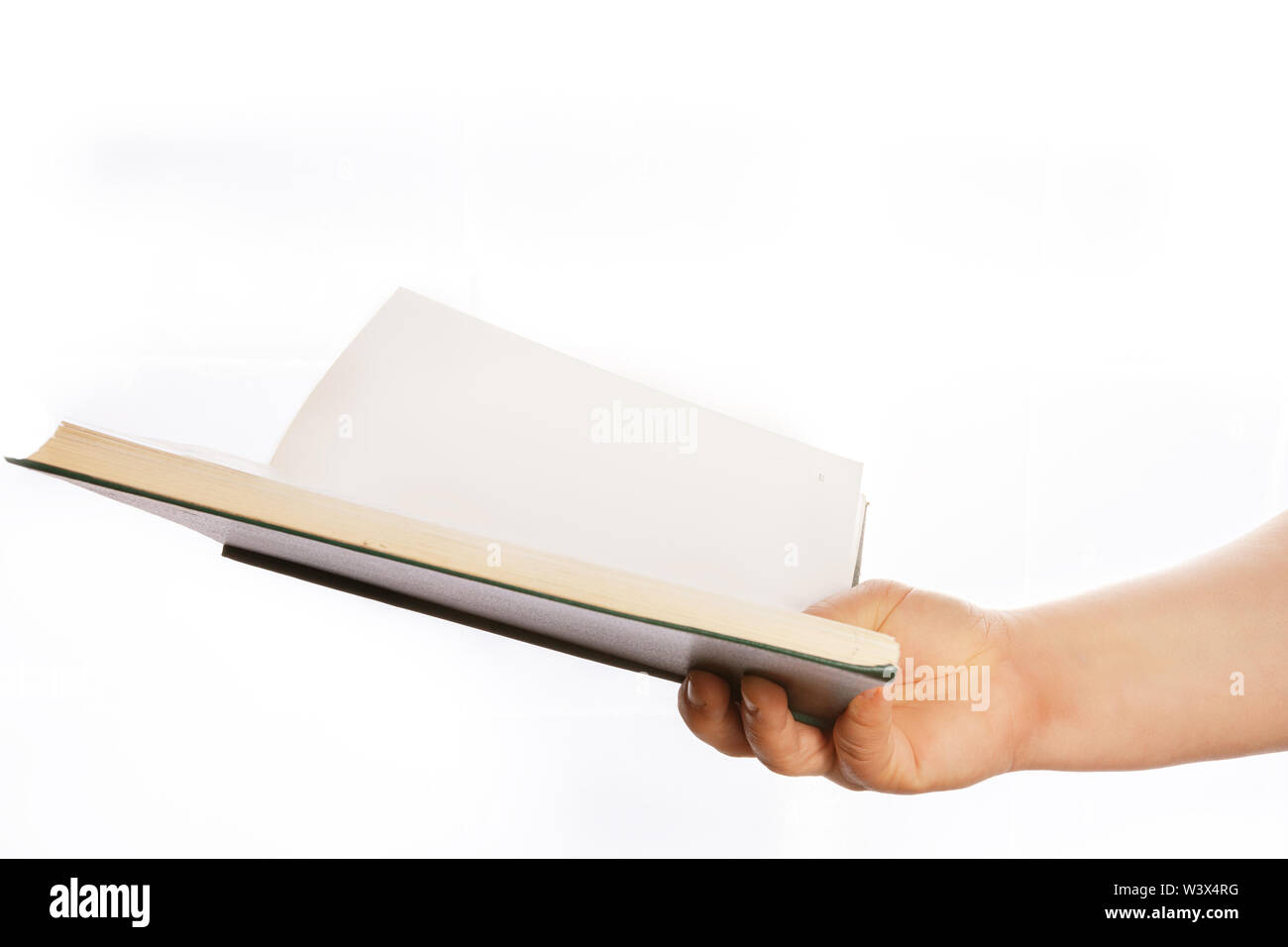 Woman's hand is holding a green book, on a white background. Blind open book. Stock Photo