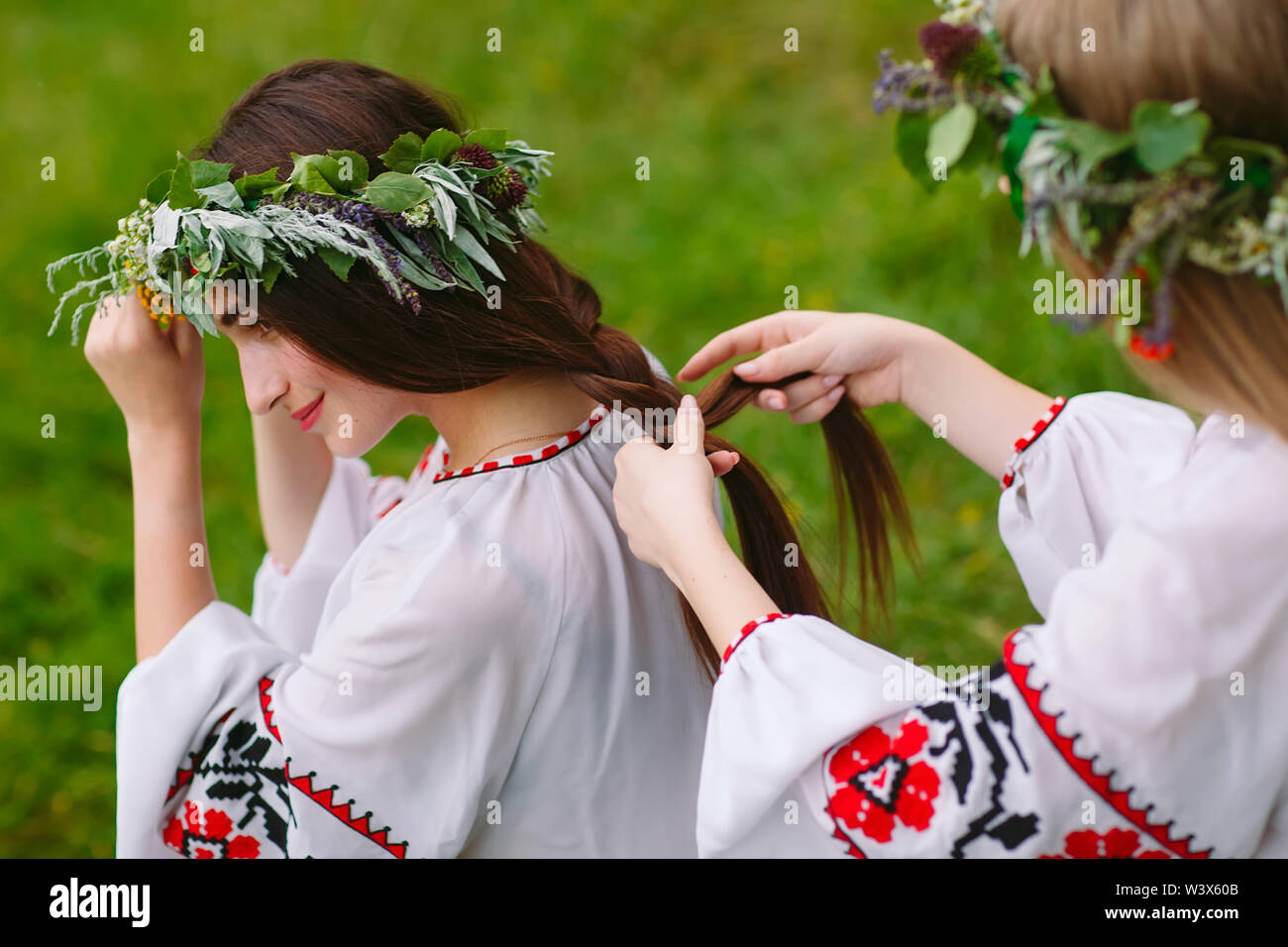 Midsummer Two Girls In The Slavic Clothes Weave Braids In