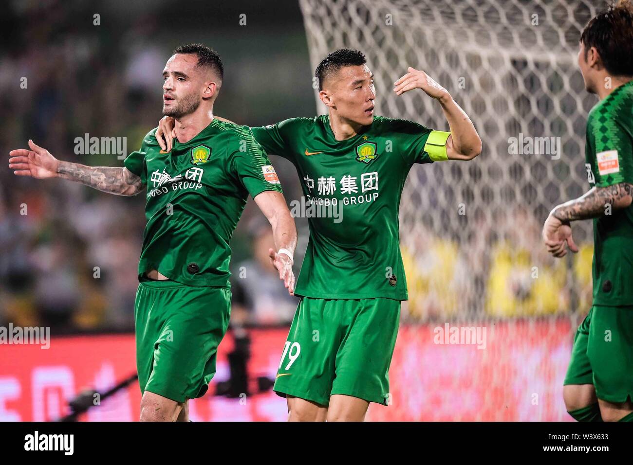 Brazilian football player Renato Soares de Oliveira Augusto, or simply Renato Augusto, left, of Beijing Sinobo Guoan celebrates with his teammates after scoring against Beijing Renhe in their 18th round match during the 2019 Chinese Football Association Super League (CSL) in Beijing, China, 17 July 2019. Beijing Sinobo Guoan defeated Beijing Renhe 2-1. Stock Photo
