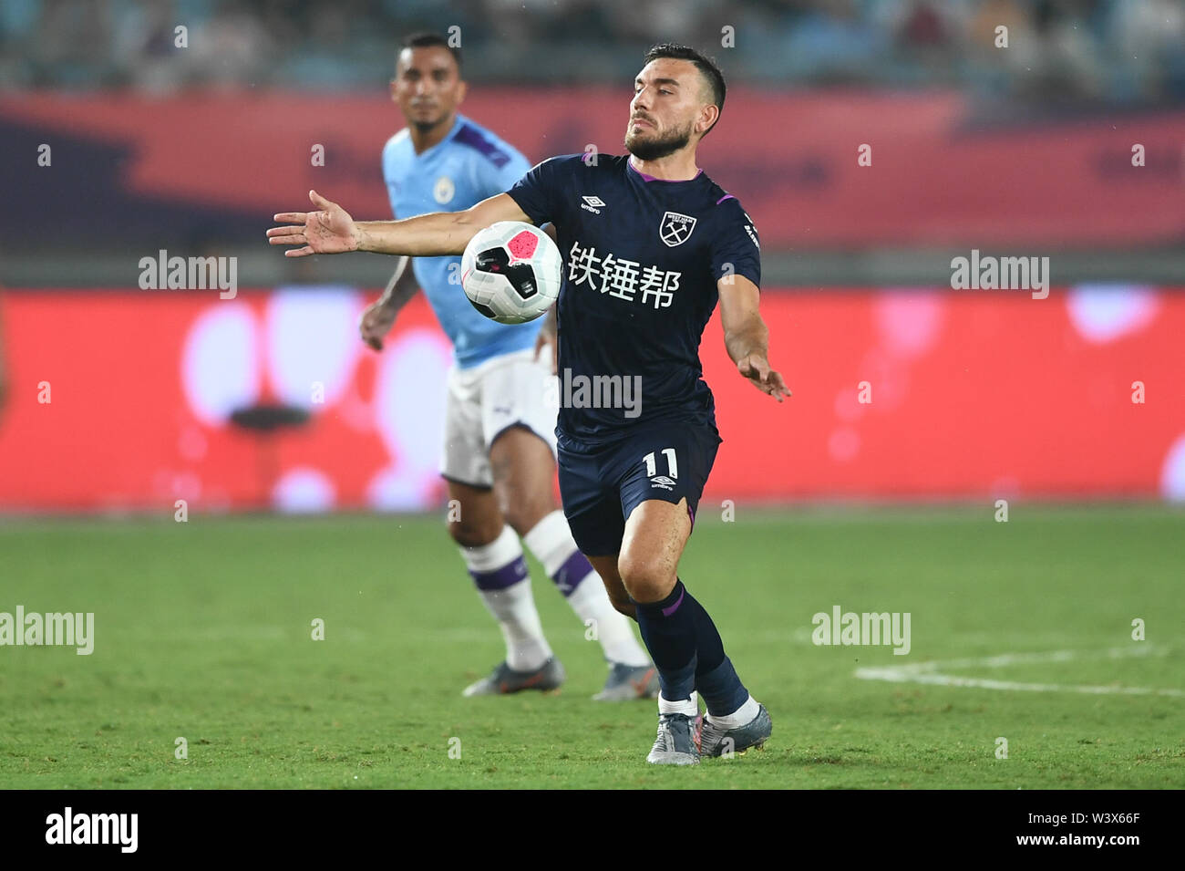 Scottish football player Robert Snodgrass of West Ham United F.C. of English League champions dribbles against Manchester City F.C. in the semifinal match of the Premier League Asia Trophy 2019 in Nanjing city, east China's Jiangsu province, 17 July 2019. Manchester City F.C. defeated West Ham United F.C. 4-1. Stock Photo