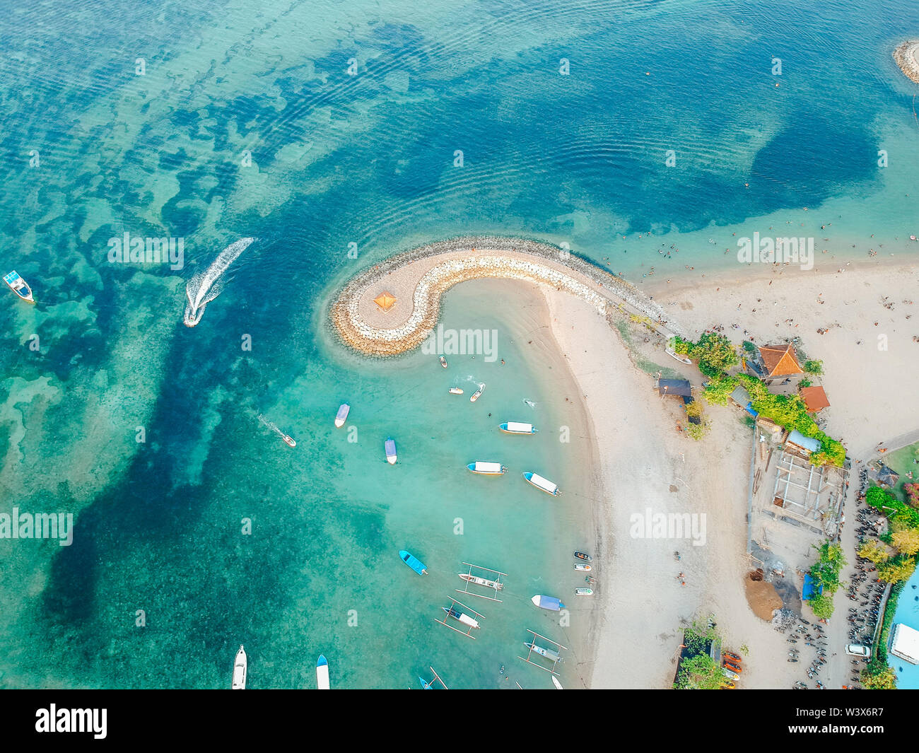 Aerial drone view of ocean, boats, beach, shore In Sanur Beach, Bali, Indonesia with with Traditional Balinese Fishing Boats amazing blue ocean. Stock Photo