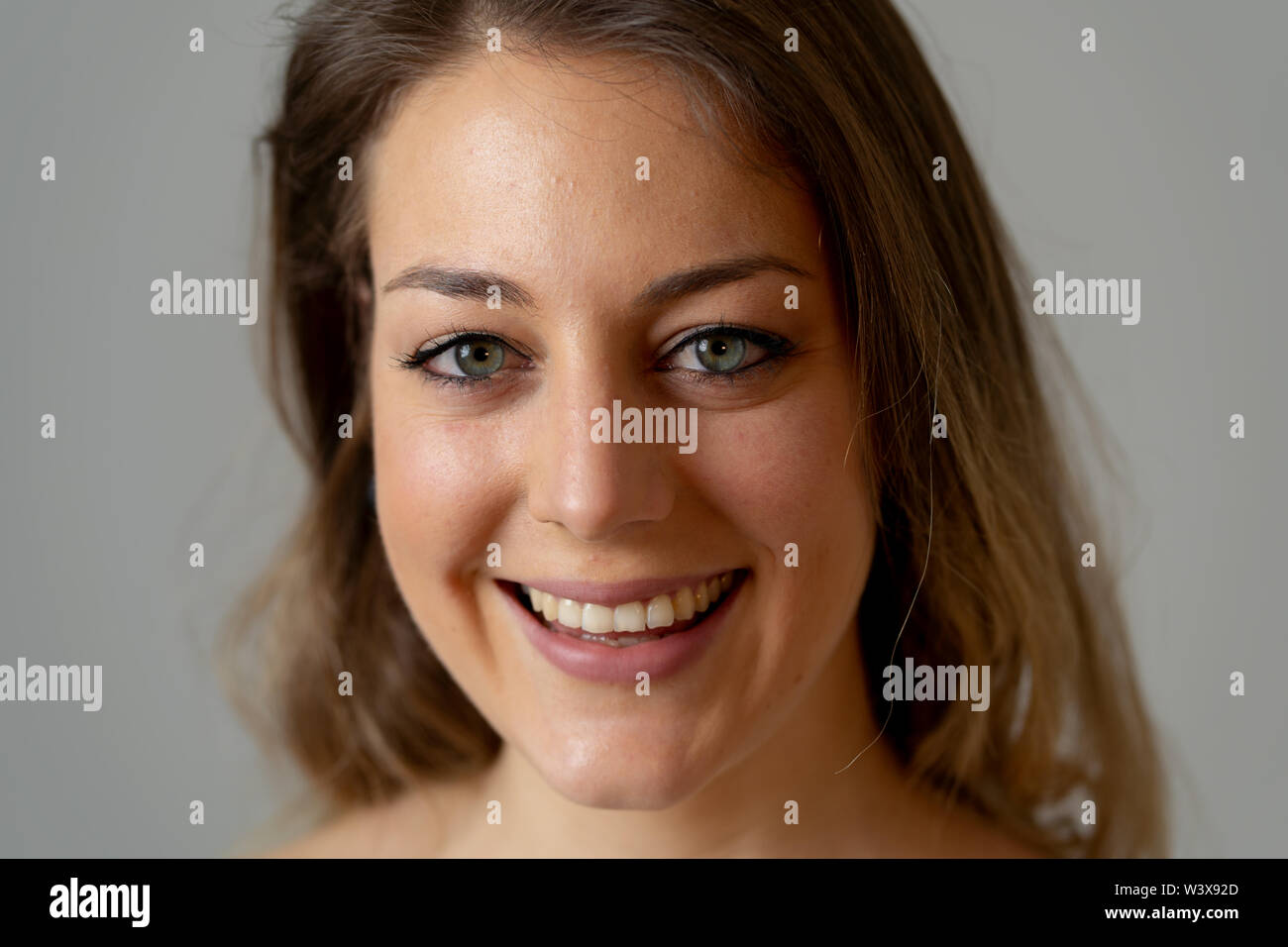 Close up portrait of attractive young caucasian woman with blond hair ...