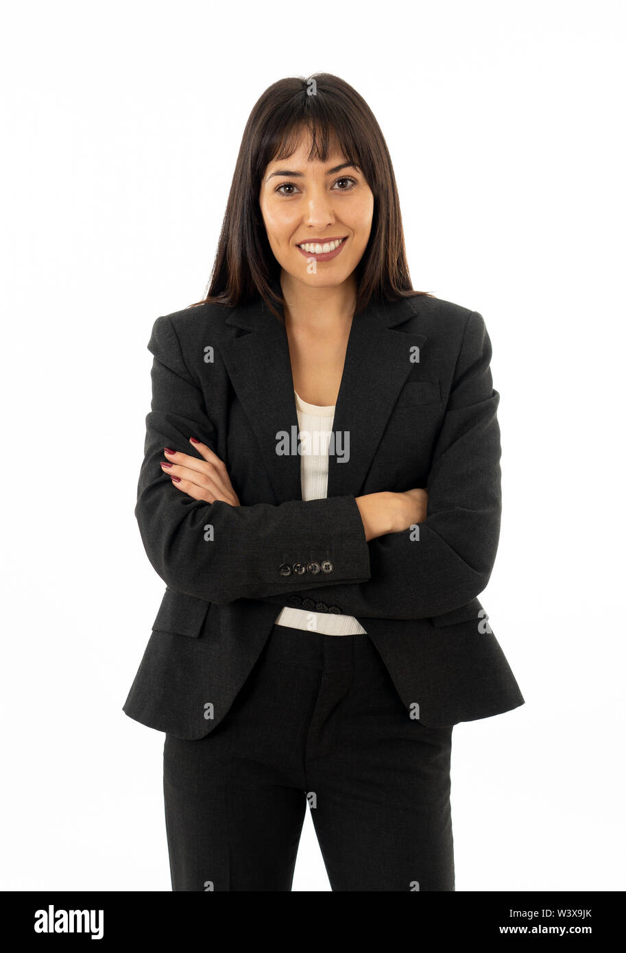 Close up of a young beautiful business woman standing isolated on neutral background. Smiling feeling confident and successful. In people business edu Stock Photo